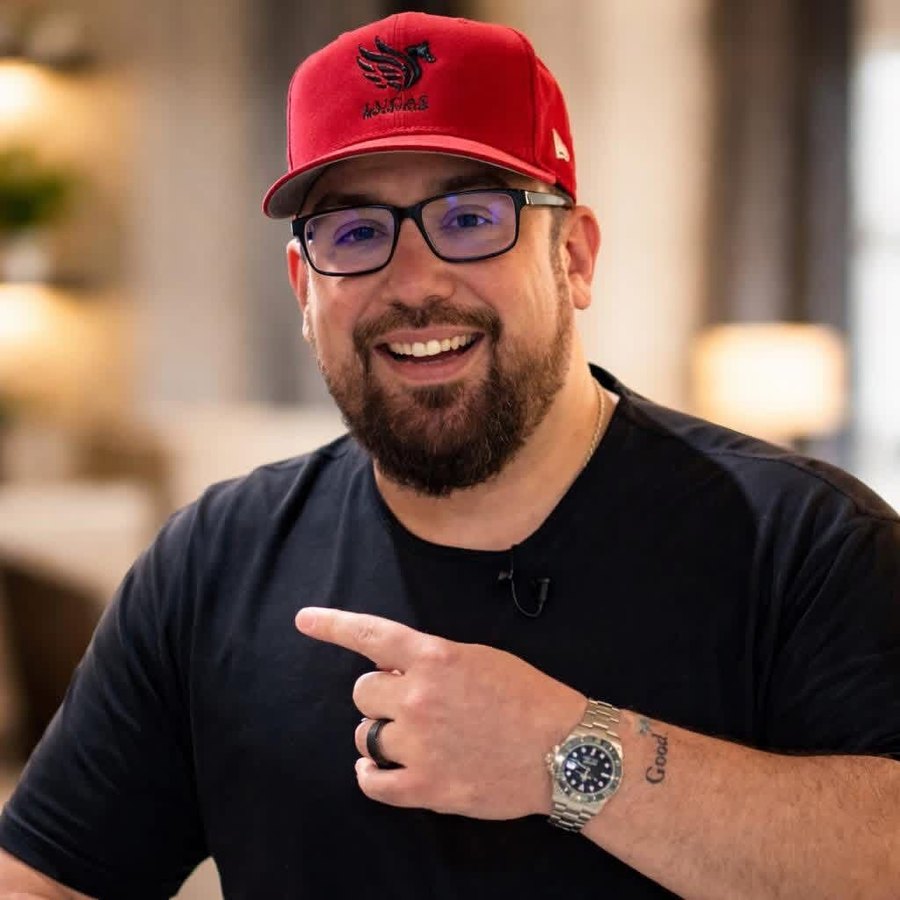 Luke Nesler in a red Lucas cap, host of the Get Rich Give Back Summit